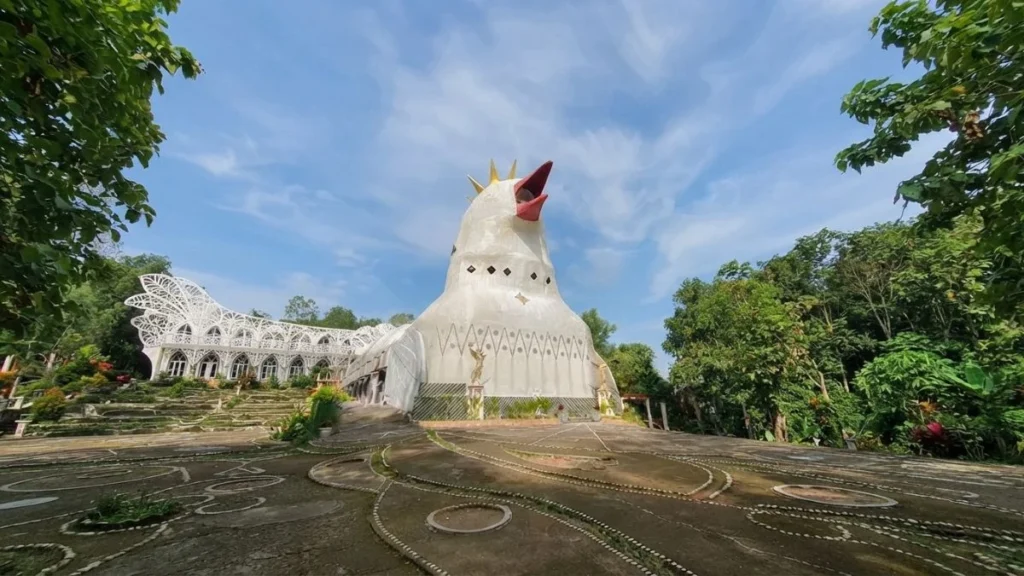 Chicken Church Yogyakarta concrete bird shaped building emerging from tropical hillside forest in morning mist