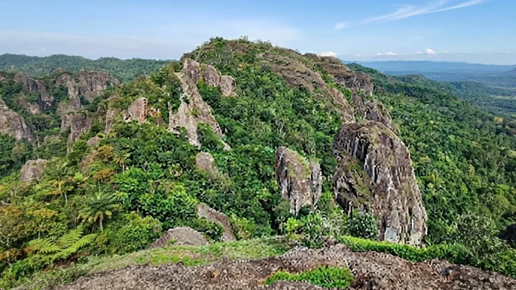 Hikers climbing boulder formations at Nglanggeran Ancient Volcano